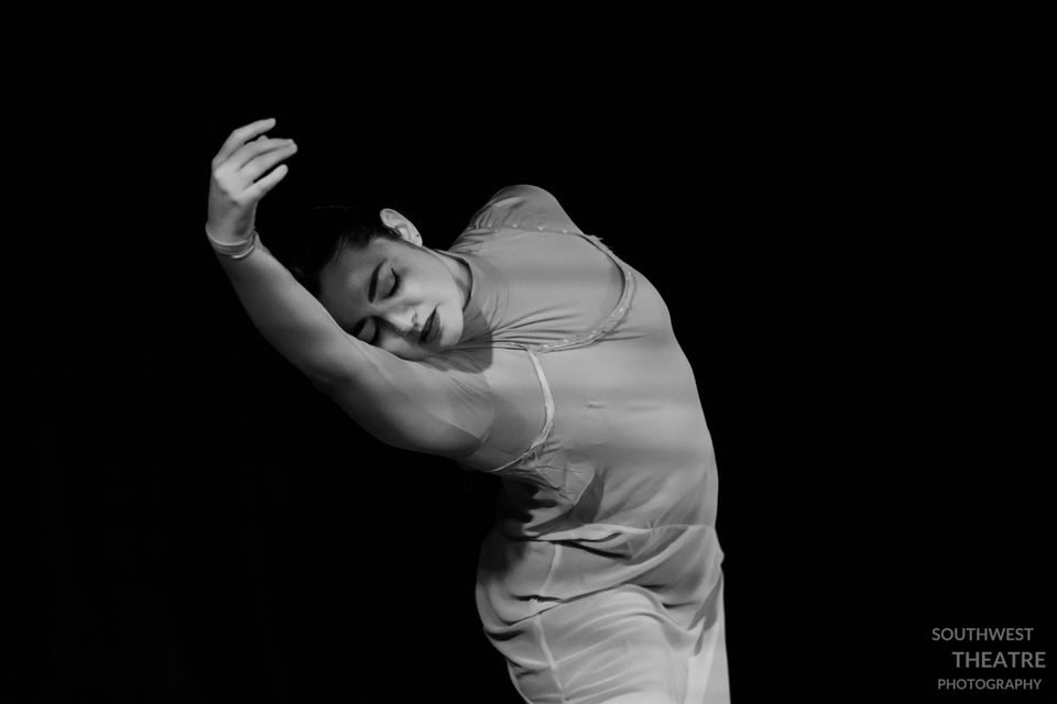 A picture of a woman mid-dance, she has her eyes closed, her heads rests on her out-streched right arm 