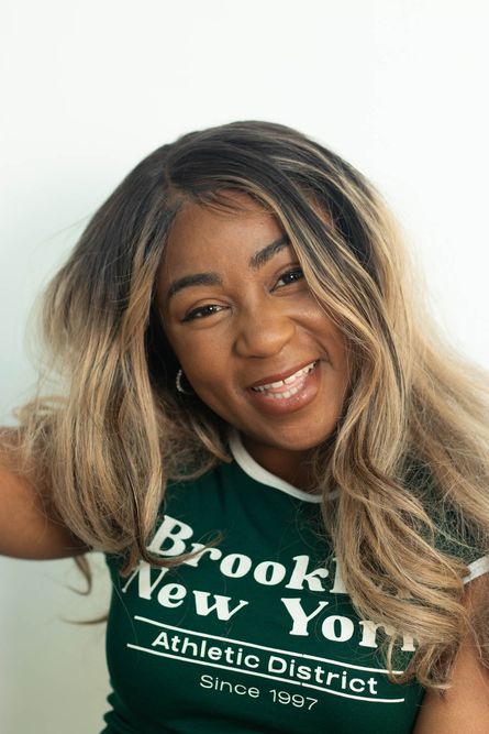 Close up photo of Creative Impact Associate Euella Jackson, smiling and looking directly at the camera 