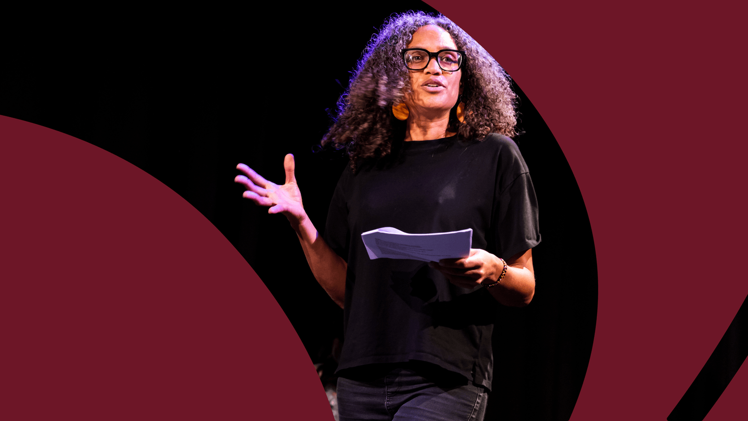 Image of a person speaking on stage