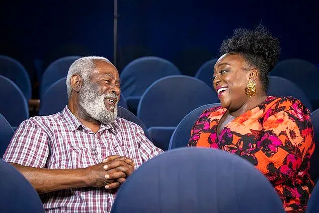Guy Bailey (an older black man with grey hair) and Judi love (a black women in her 40s with an afro in a bun) are sat down looking at each other and laughing