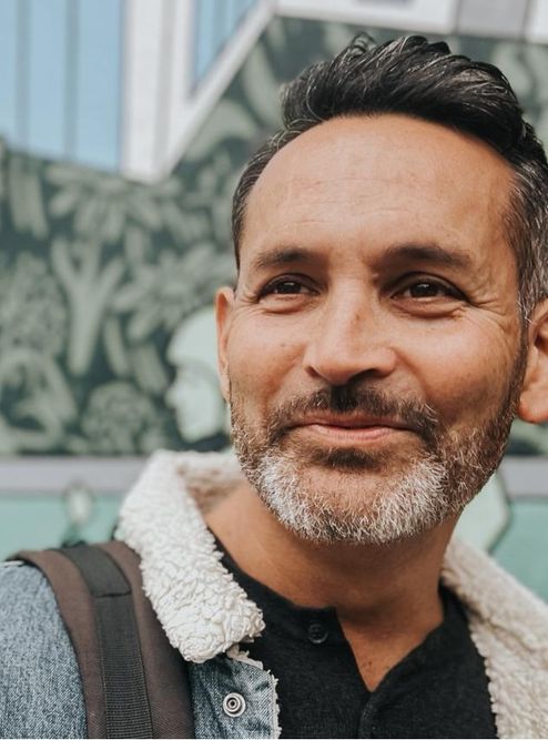 A man with smiles gently past a camera