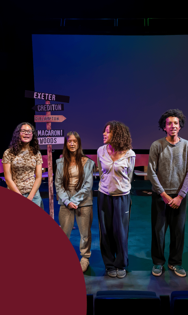Four young people stand on stage